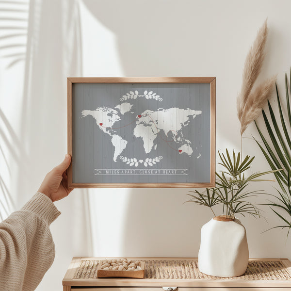 Person holding a framed custom world map print showing the scale and high-quality matte finish