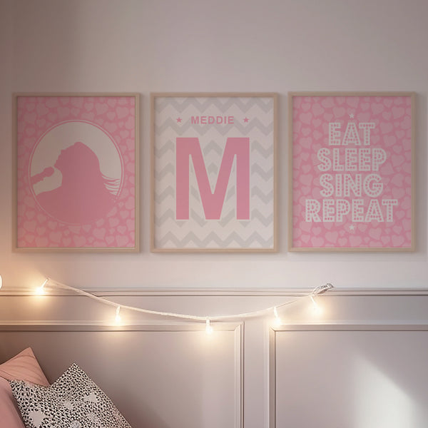 Soft Pink music art prints hanging above a bed in a romantic kids room
