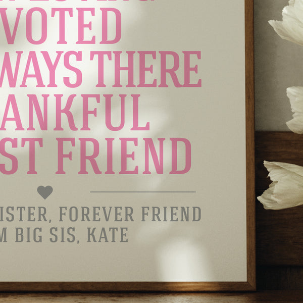 Framed sister words print with pink text on a neutral background