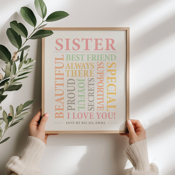 Framed print with heartfelt message about sisterhood held by a person against a light background.
