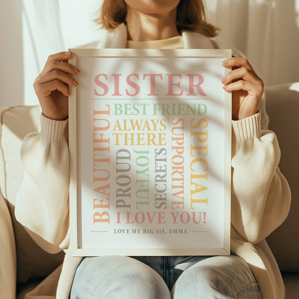 Person holding a framed print with affectionate phrases about a sister.